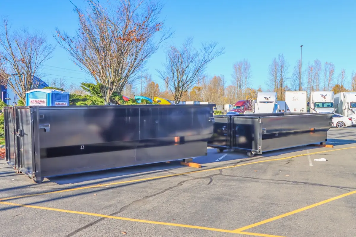 Professional dumpster rental service with roll-off container on residential driveway in North Tonawanda